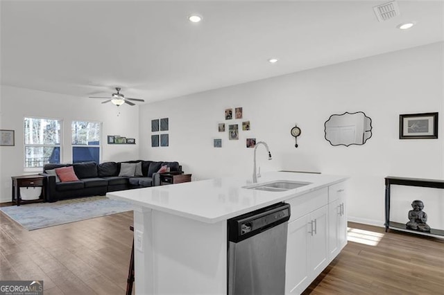 kitchen featuring white cabinetry, light hardwood / wood-style floors, a center island with sink, dishwasher, and sink