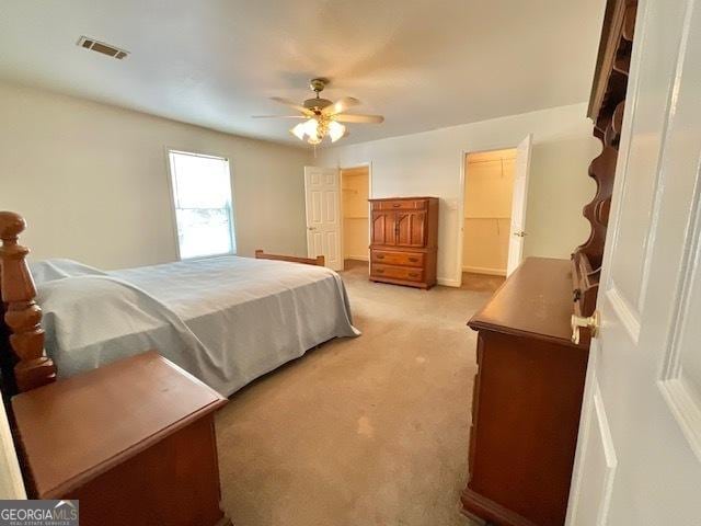 bedroom with ceiling fan and light carpet