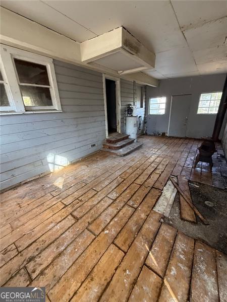 miscellaneous room with wood walls