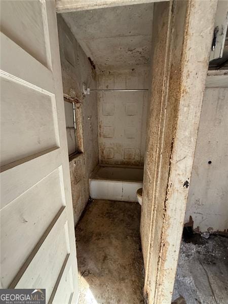 bathroom with concrete flooring