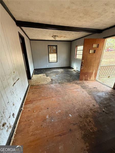 interior space featuring wood walls and beamed ceiling