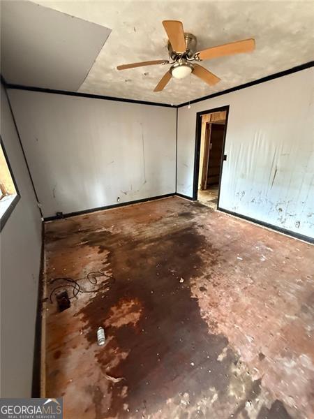 unfurnished bedroom with ceiling fan and concrete floors