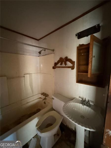 bathroom featuring washtub / shower combination and toilet