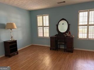 interior space with plenty of natural light and wood-type flooring