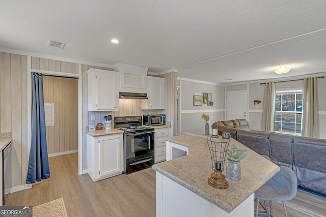 kitchen with exhaust hood, a center island, crown molding, white cabinetry, and stainless steel appliances