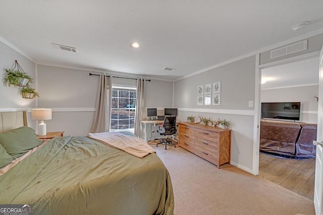 bedroom with light wood-type flooring and crown molding