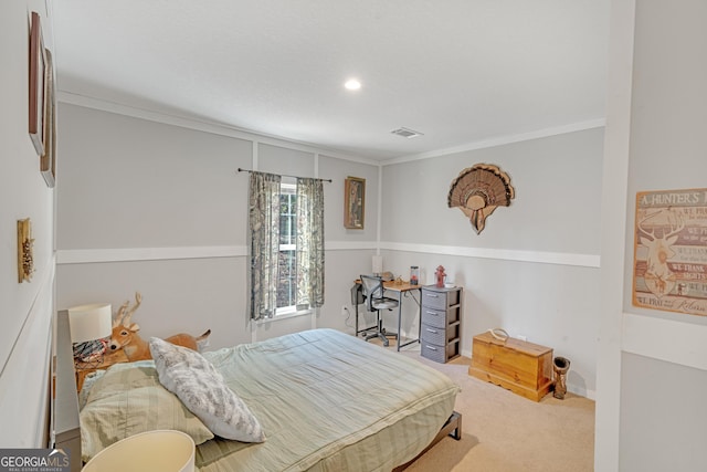 bedroom with ornamental molding and carpet flooring