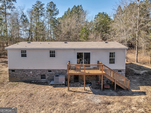 rear view of house with a deck and central air condition unit