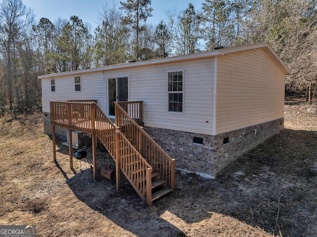 rear view of property featuring a deck