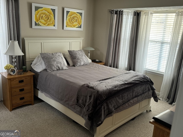 bedroom with light colored carpet