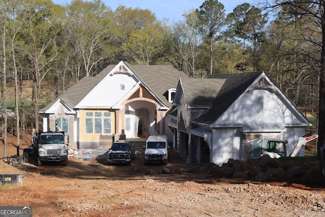 view of front facade with roof with shingles