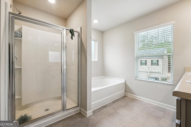 bathroom with separate shower and tub and vanity