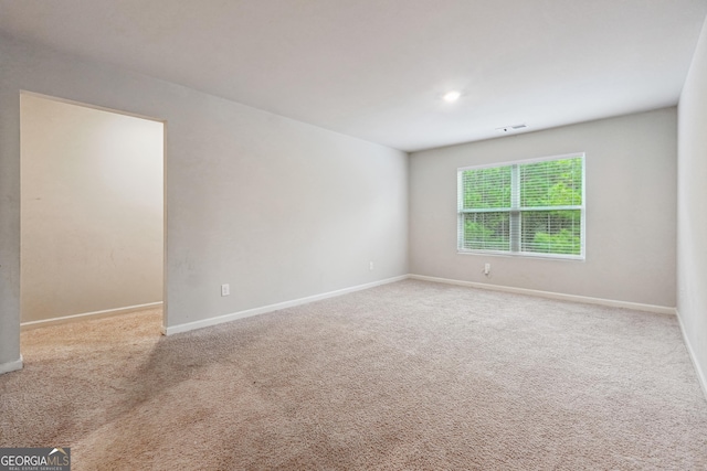 unfurnished room featuring light colored carpet