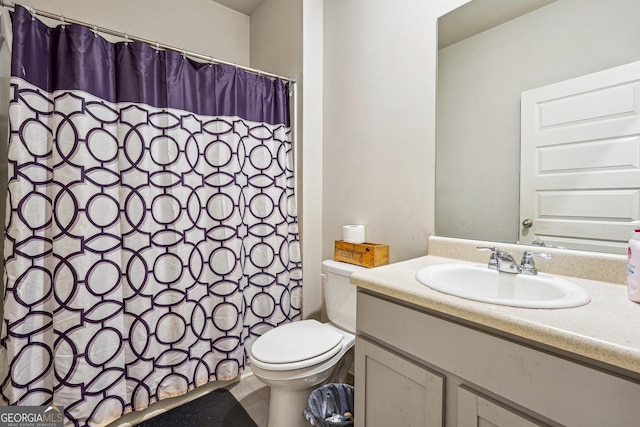 bathroom featuring toilet and vanity