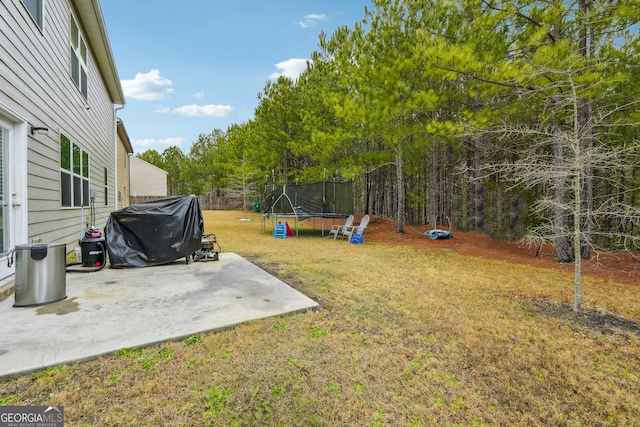 view of yard featuring a patio area and a trampoline