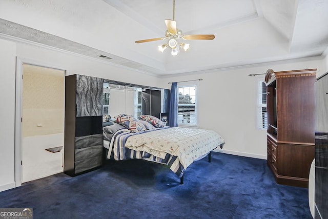 bedroom with visible vents, baseboards, ornamental molding, a tray ceiling, and carpet floors