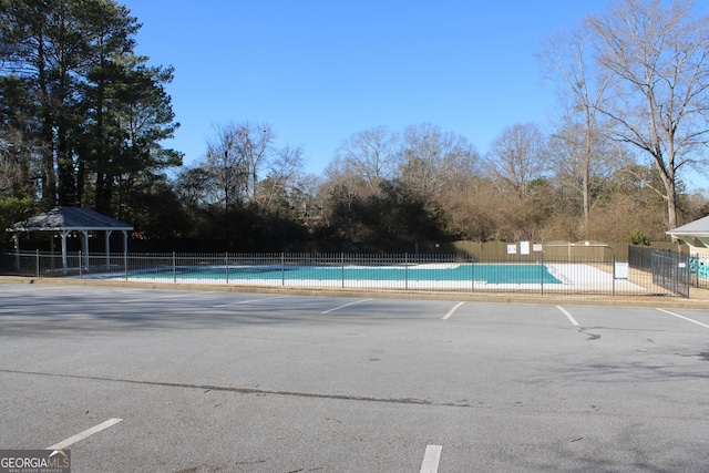 pool featuring a gazebo and fence