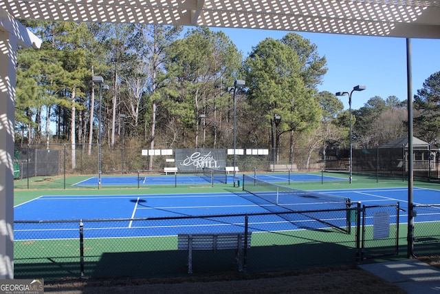 view of tennis court with fence