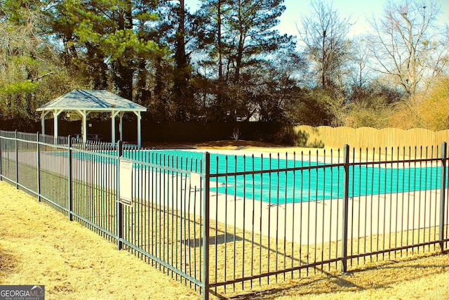 view of swimming pool featuring a fenced in pool, fence, and a gazebo