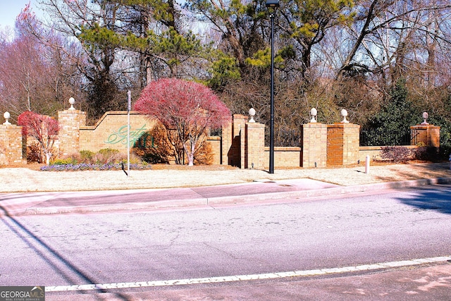 exterior space featuring street lighting and curbs