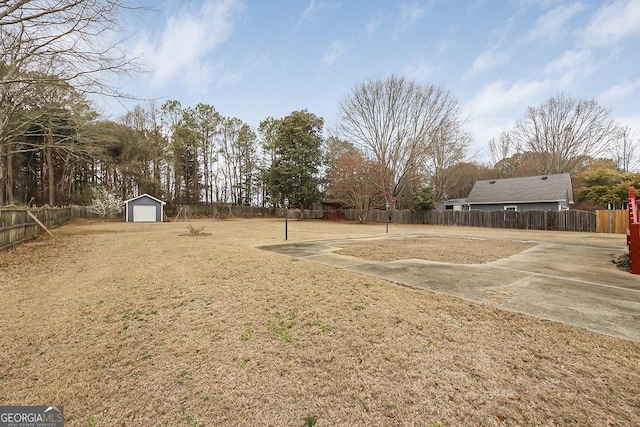 view of yard with fence private yard and an outbuilding