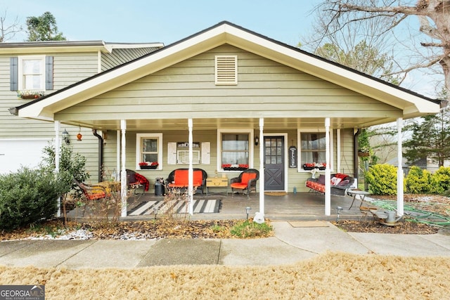 view of front of home with a porch and a garage