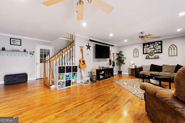 living room featuring ceiling fan, ornamental molding, and wood-type flooring