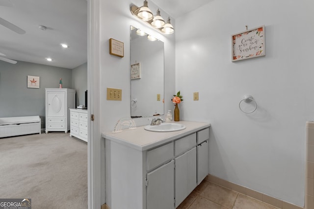 bathroom with tile patterned flooring, baseboards, and vanity