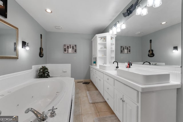 bathroom featuring double vanity, visible vents, a sink, tile patterned flooring, and a whirlpool tub