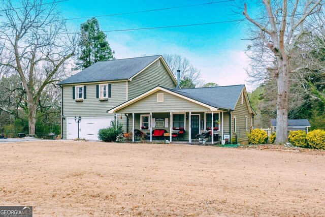 view of front of home with a garage and a porch