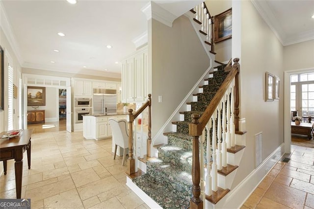 staircase featuring crown molding