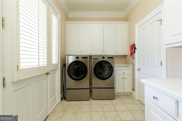 laundry area with cabinets, light tile patterned floors, a healthy amount of sunlight, and independent washer and dryer