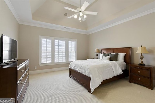 carpeted bedroom featuring ceiling fan, crown molding, and a raised ceiling