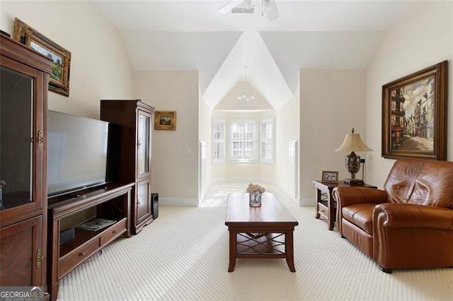 carpeted living room featuring ceiling fan and vaulted ceiling