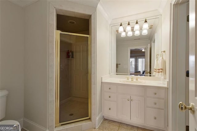 bathroom with toilet, tile patterned flooring, walk in shower, crown molding, and vanity