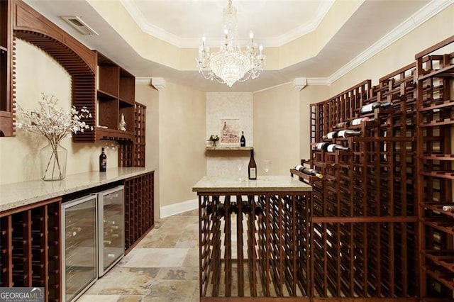 wine cellar featuring a raised ceiling, wine cooler, crown molding, and an inviting chandelier