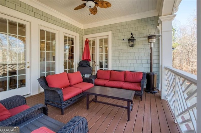 wooden terrace with ceiling fan and an outdoor living space