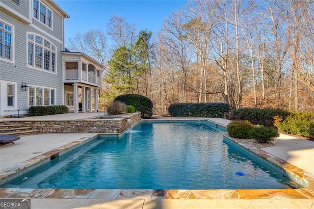 view of swimming pool with a patio area