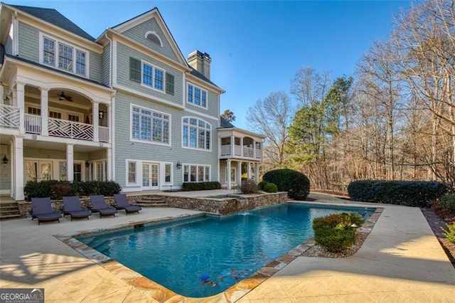 view of pool with pool water feature and a patio area