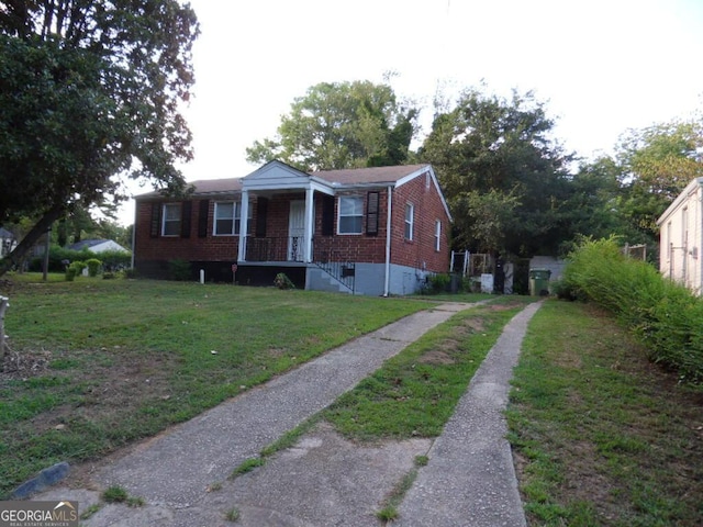 bungalow-style home with a front yard