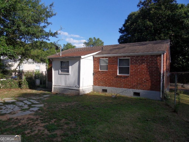 back of house with a yard