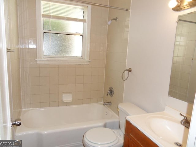 full bathroom with toilet, tiled shower / bath combo, and vanity