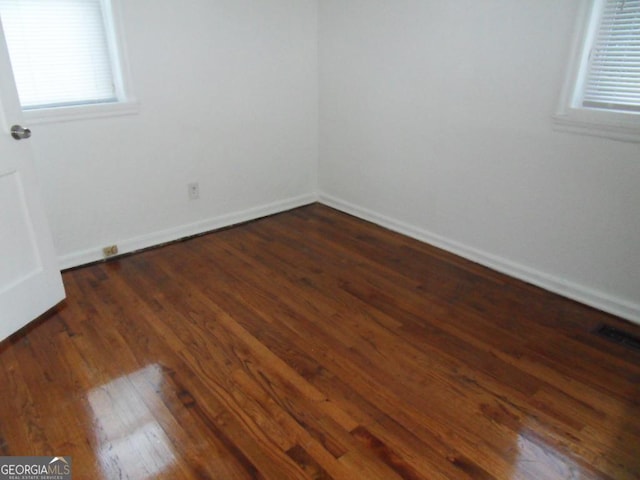 unfurnished room featuring dark hardwood / wood-style floors