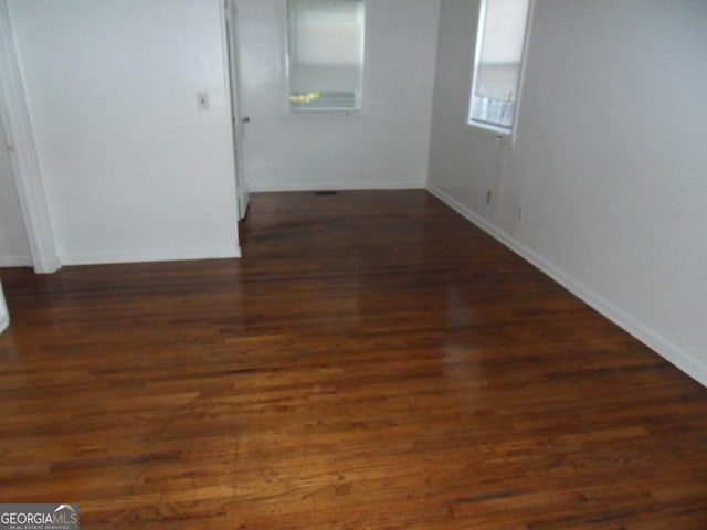 unfurnished room with dark hardwood / wood-style floors