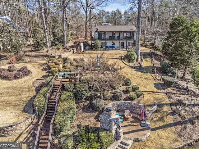 rear view of property with a patio area and a fire pit