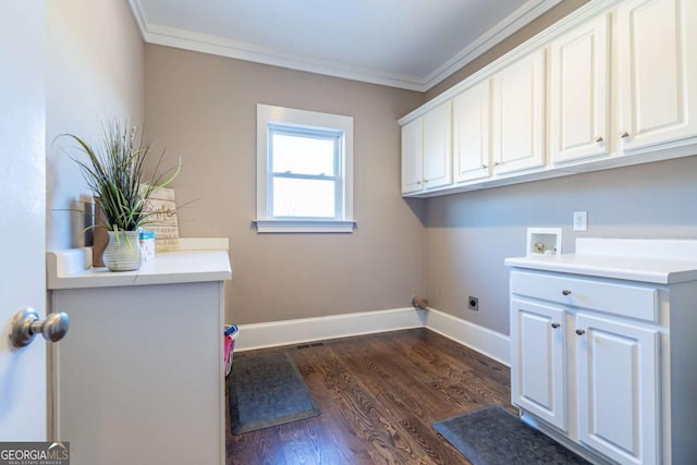 clothes washing area with cabinets, dark wood-type flooring, electric dryer hookup, washer hookup, and crown molding