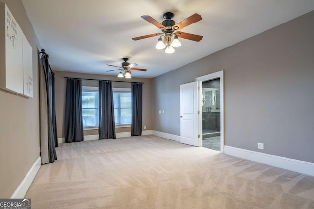 carpeted spare room featuring ceiling fan