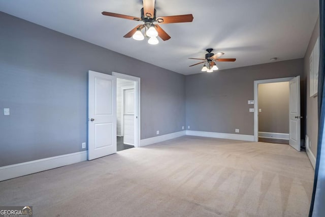 unfurnished bedroom with ceiling fan and light carpet