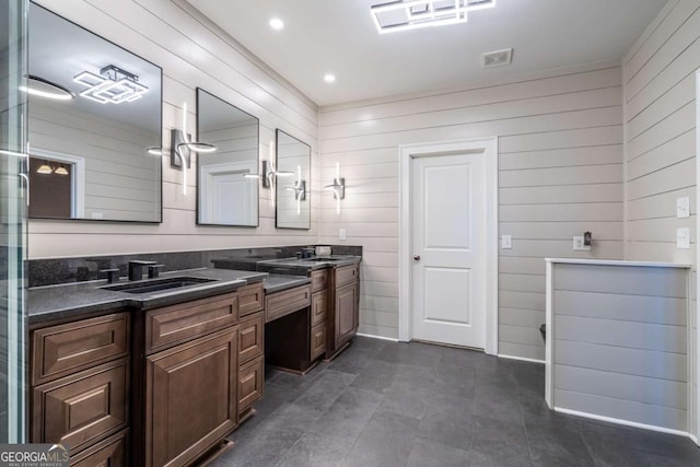 bathroom with wood walls and vanity