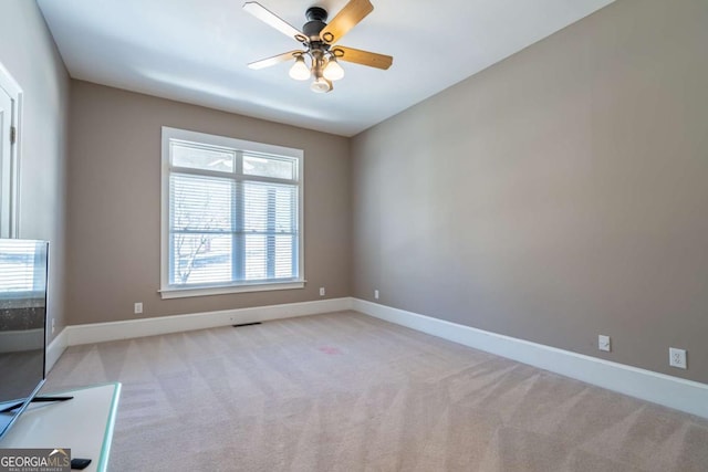 carpeted empty room with ceiling fan